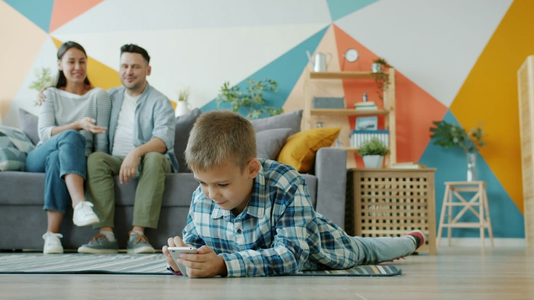 Family relaxing in a naturally lit living room